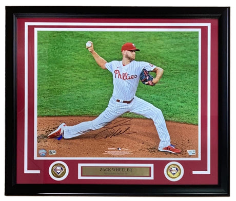 The Sports Integrity Zack Wheeler Signed Framed 16x20 Philadelphia Phillies Photo by Fanatics features the Phillies pitcher mid-pitch in uniform, with a nameplate and two team logos in the bottom corners.