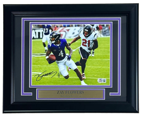 Sports Integrity Zay Flowers Signed Framed 8x10 Baltimore Ravens Photo (BAS) features Zay running with the football versus a Texans defender, displayed with a labeled nameplate.