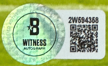 A Sports Integrity holographic sticker with a large B, "WITNESS AUTOGRAPH," code 2W594358, and QR code appears on this Zay Flowers Signed Framed 8x10 Baltimore Ravens Photo BAS, set against a yellow-green background.